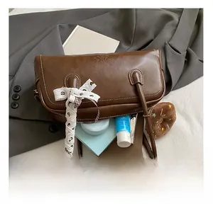 Internal capacity of brown vintage underarm bag showing space for phone and makeup