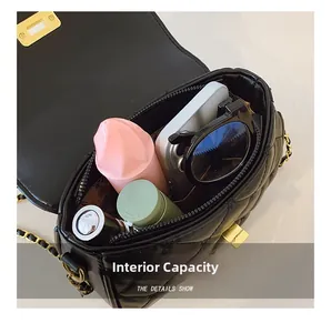 Interior view of quilted black crossbody bag showing space for phone and makeup
