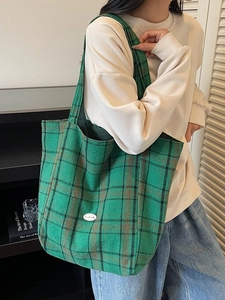 Green and black plaid canvas tote bag with a handmade label and spacious interior