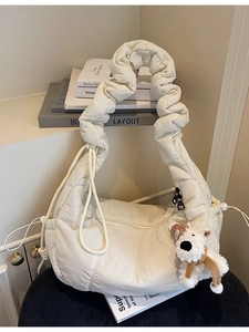 Quilted off-white canvas tote bag with ruched strap and cute puppy pendant