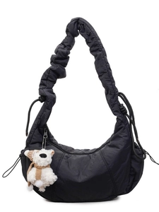 Large black quilted half-moon canvas shoulder bag with a cute bear charm for daily commute