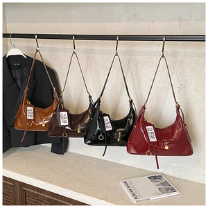 Detail of vintage tote bags in four colors with gold zippers and decorative key locks