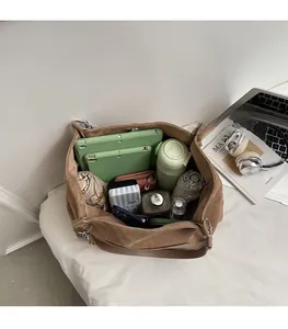 Interior view showing the large capacity of the brown tote bag for daily travel essentials