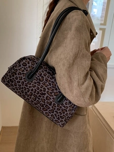 Chic leopard print baguette bag with black leather shoulder strap for stylish women