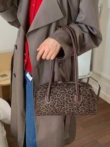 Retro leopard print baguette bag with brown leather handles and silver zipper closure