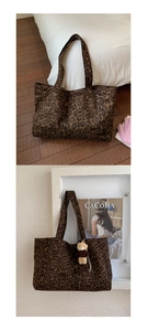 Close-up of leopard print tote bag with plush bear charm and long shoulder straps