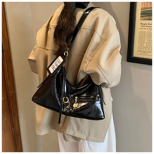 French retro black hobo bag with golden hardware shown as crossbody style on a model