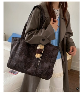 Large leopard print canvas tote bag with a cute bear charm shown on shoulder