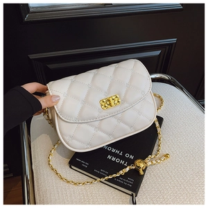 Close-up of white quilted leather bag featuring a gold clasp and leather-chain strap