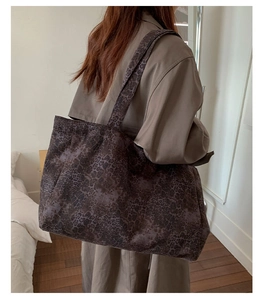 Close-up of leopard print canvas tote bag showing soft fabric texture and dual straps