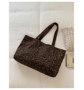 Macro shot of large leopard print tote bag detailing fabric texture and patterns