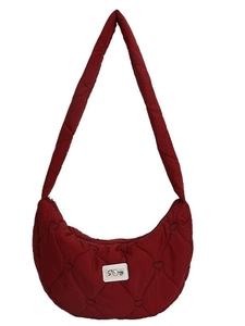 Burgundy heart-quilted puffer crescent bag with shoulder strap and sturdy logo patch