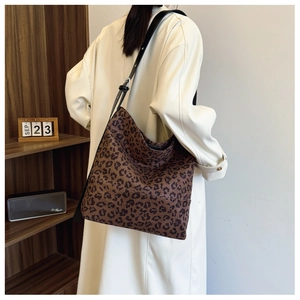 Detail of leopard print tote bag showing large capacity and adjustable leather shoulder strap