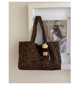 Detailed shot of leopard print canvas tote with a cute brown bear charm on the handle