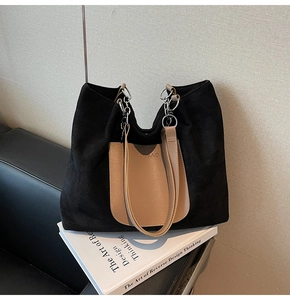Detail of suede tote bag featuring contrast leather pocket and silver ring strap connector
