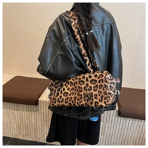 Détail du sac léopard montrant la texture en peluche et la boucle métallique sur le côté