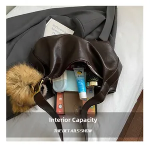 Intérieur spacieux du cabas marron foncé avec téléphone et cosmétiques quotidiens