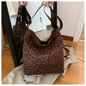Detail of large leopard print tote bag with adjustable grommet shoulder strap