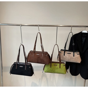 Detail view of four minimalist suede tote bags in black, brown, green and beige colors