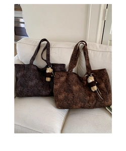 Detailed view of large leopard print tote bags in dark coffee and light brown colors