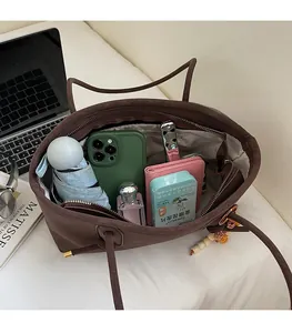 Detail view of coffee brown tote bag interior showing spacious capacity for daily essentials