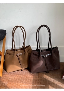 Detail view of tan and dark coffee retro leather tote bags with minimalist buckles