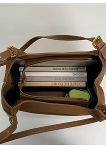 Spacious interior of brown faux suede tote bag showing zipper compartment and large capacity