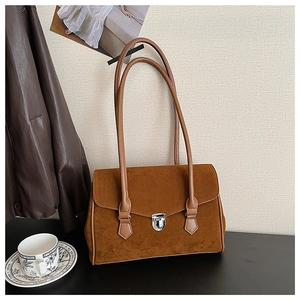 Detail of vintage brown frosted texture shoulder bag with silver metal flip lock closure