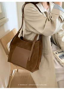 Detail of vintage brown suede patchwork tote bag with adjustable strap and front pocket
