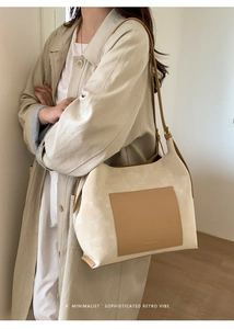 Chic beige faux suede tote bag with brown pocket worn by a model in minimalist style