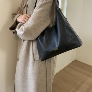Close-up of black leather tote bag featuring gold PAN'TOR LONDON lettering and soft texture