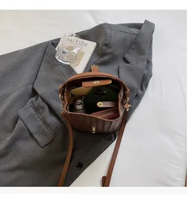 Interior view of brown woven bucket bag showing spacious storage for daily essentials