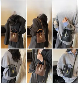 Detail of woven leather bucket bag with top handle, detachable strap, and metal lock