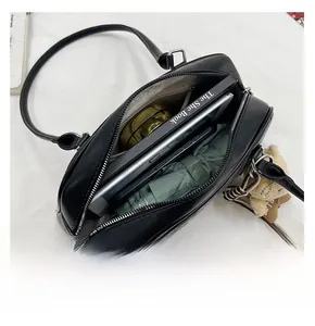 Top view of spacious interior storage for a black leather tote bag with daily items