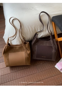 Detailed view of suede patchwork tote bags with front pockets and brand lettering
