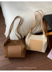 Detail of minimalist retro faux suede tote bags in brown and beige with adjustable straps