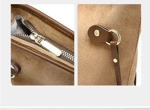 Detail of smooth metal zipper and matte gold hardware on leopard print tote bag