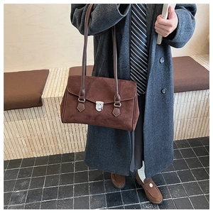 Detail of vintage brown frosted suede underarm bag featuring silver metal swivel lock
