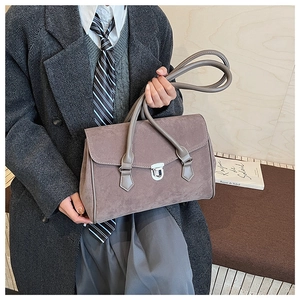 Detail of vintage matte leather underarm bag with silver buckle and British style aesthetic