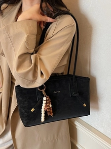Fashionable black suede tote bag for women with decorative beads and slim shoulder straps