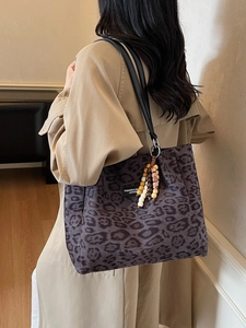 Large leopard print tote bag with purple accents and beaded charm strap details