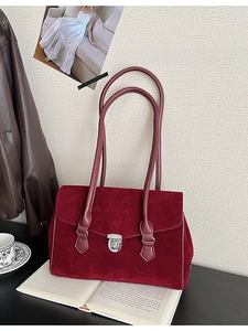 Vintage burgundy matte suede underarm bag with silver buckle in a retro aesthetic