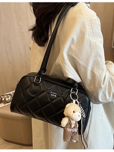 Chic black quilted shoulder bag with teddy bear pendant and elegant metal logo