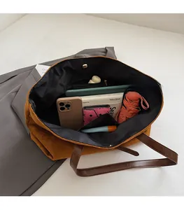 Detailed interior of large mustard suede tote bag showing spacious storage capacity