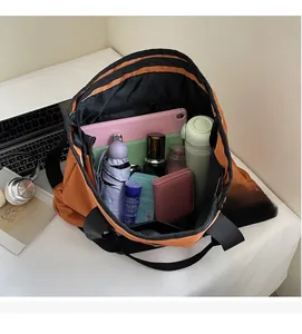 Interior view of a large orange canvas bag filled with a tablet, bottle, and daily items