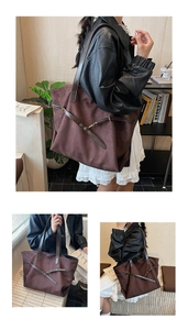 Close-up detail of vintage brown suede tote bag with leather straps and buckle decor