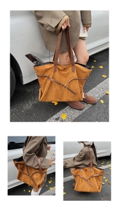 Close-up of vintage dark camel suede tote bag with brown leather handles and side buckle