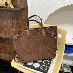Close-up of the vintage brown faux suede tote bag with elegant gold metal ring detail