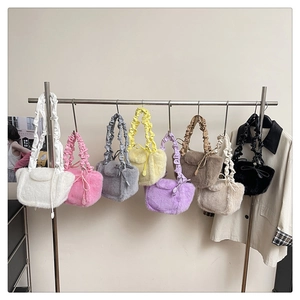 Detail of plush tote bags in eight colors featuring ruffled handles and bow accents