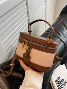 Sac seau vintage en cuir marron et toile beige avec poignée supérieure et bandoulière